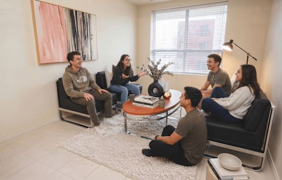 A group of people sitting in a circle in a room.