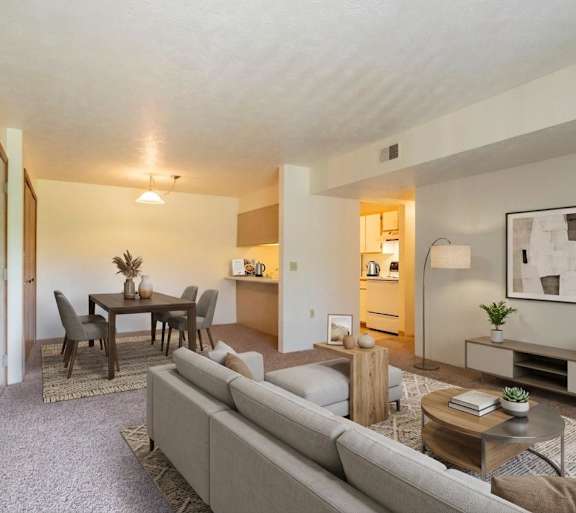 A living room with a grey couch and a coffee table.