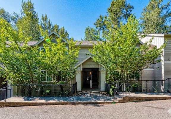 A house with a front yard and trees.