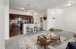 A modern kitchen with a dining area and a living room.