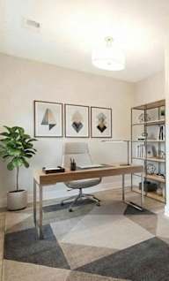 A room with a desk and a chair in it.