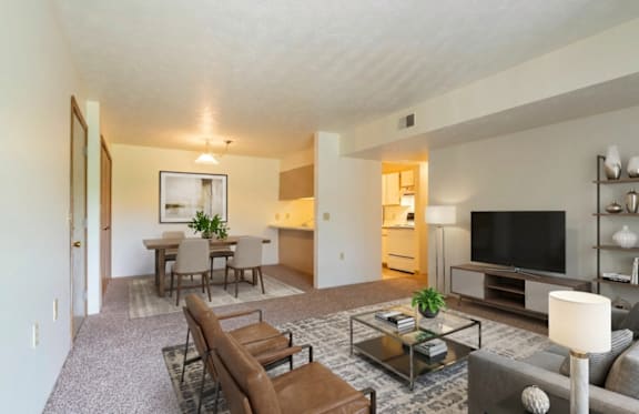 A living room with a couch, chair, and coffee table.