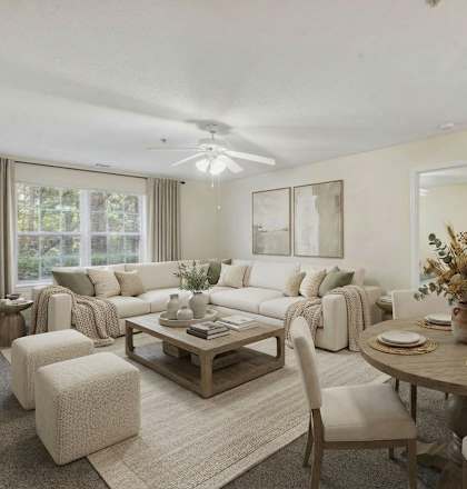 A well-lit living room with a dining table set for four.