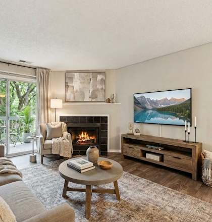 A living room with a fireplace and a painting on the wall.