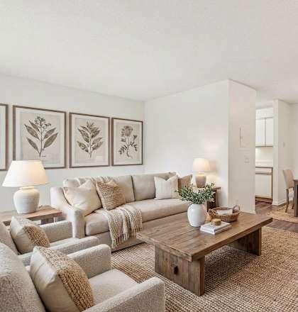 A living room with a couch, chairs, and a coffee table.