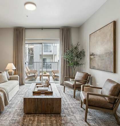 A living room with a couch, chairs, and a coffee table.