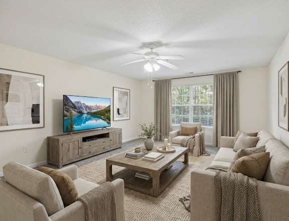 A living room with a television, couches, and a coffee table.