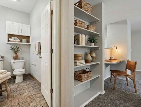 A bathroom with a toilet, a sink, and a chair.