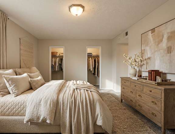 A bedroom with a large bed and a dresser.