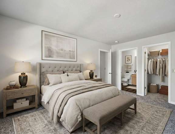 A bedroom with a large bed and a bench in front of it.