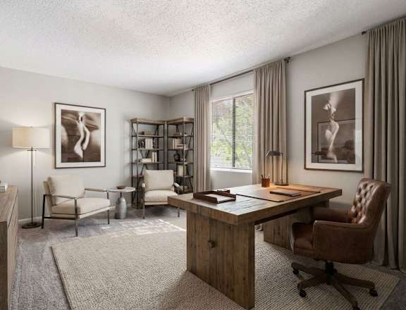 A well-lit room with a desk, chairs, and a bookshelf.