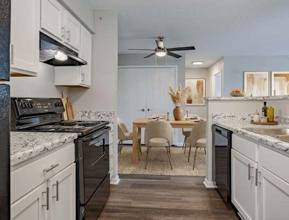 A kitchen with a table and chairs in the middle of it. at Arbors at Hickory Creek Apartments , Illinois