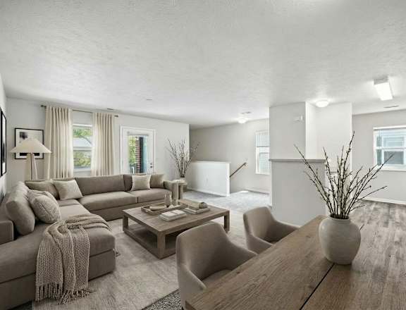 A modern living room with a grey sofa and a wooden coffee table.
