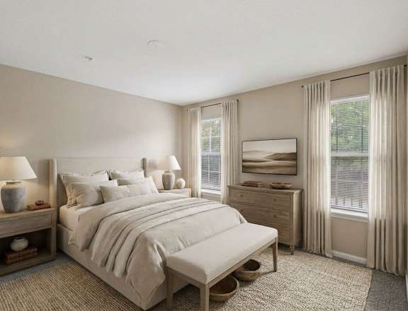 A bedroom with a large bed, nightstand, and window.