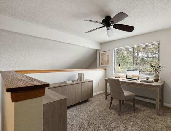 A room with a desk, chair, and a fan.