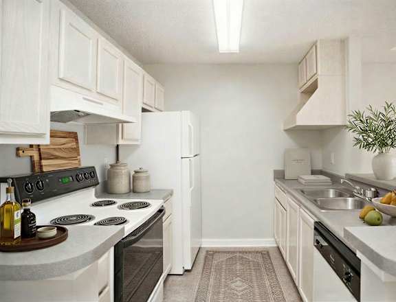 A kitchen with white cabinets and a black stove top.