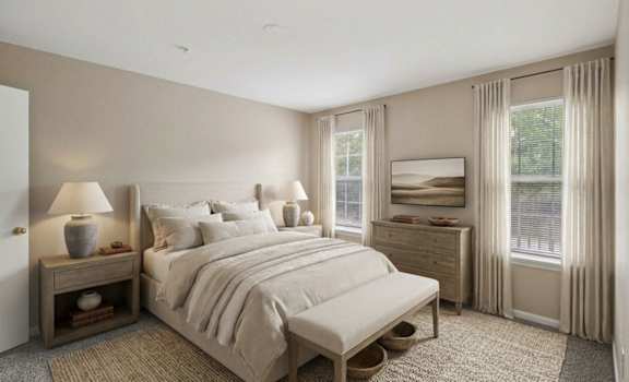 A bedroom with a large bed, nightstand, and window.