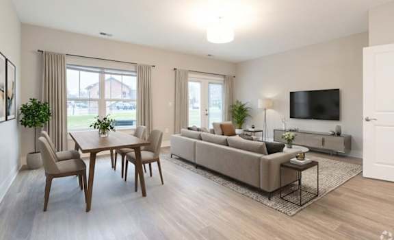 A living room with a couch, chairs, and a television.