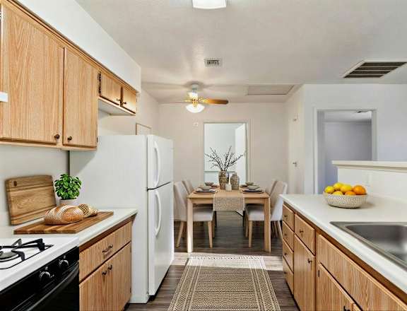 A kitchen with wooden cabinets and a white refrigerator.