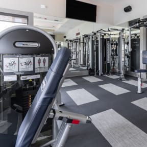 a fitness room with a treadmill and other exercise equipment