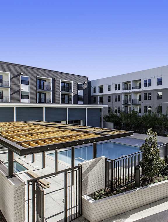 A modern building with a pool and a balcony.