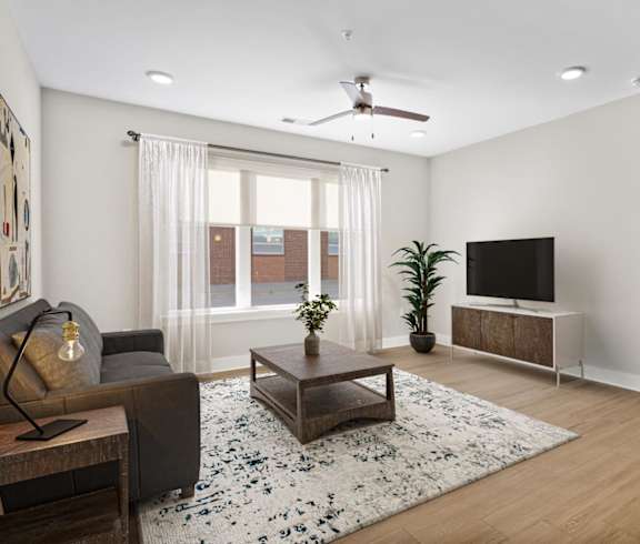 a living room with a white couch and a glass table
