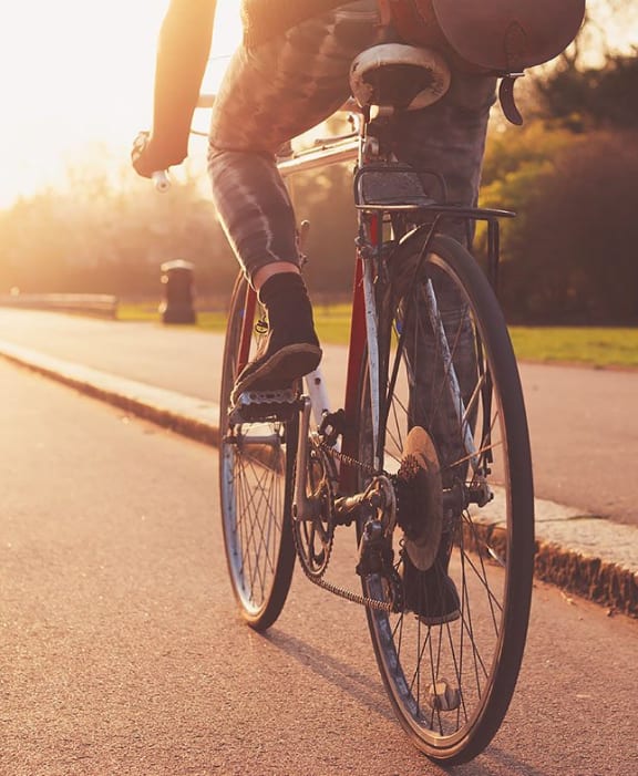 a person riding a bike down a street