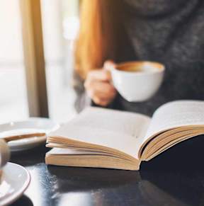 Woman in Coffee Shop with Book  at Vintage at Lockwood Apartments, Oxnard 93036