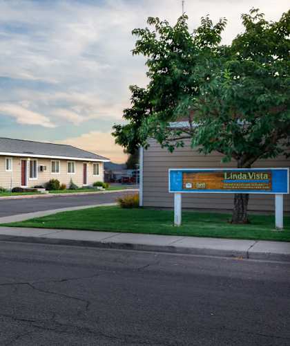 A street view of Linda Vista apartments with a blue sign.