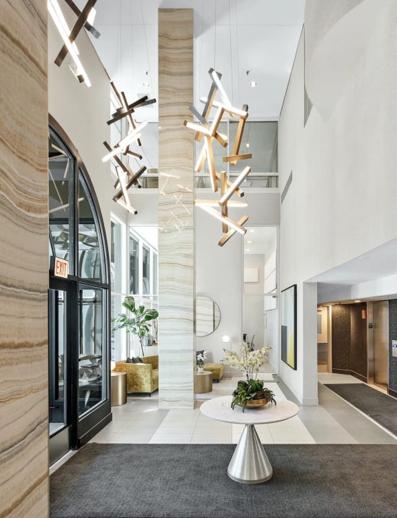 a lobby with a round table and chandeliers