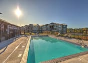 Thumbnail 4 of 19 - Pool with lounge chairs at GATEWAY BY VINTAGE, Spanaway Washington