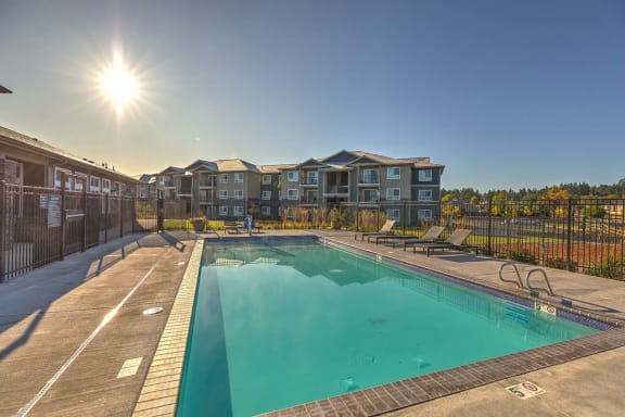 Pool with lounge chairs at GATEWAY BY VINTAGE, Spanaway Washington