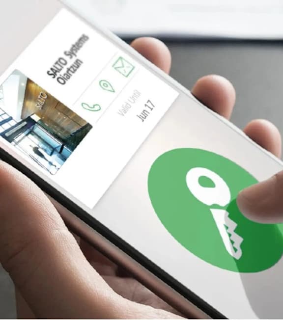 A person is holding a phone with a key icon on the screen.at Sylk Towers, Ontario