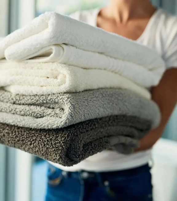 A person holding a stack of towels.at Sylk Towers, Ontario