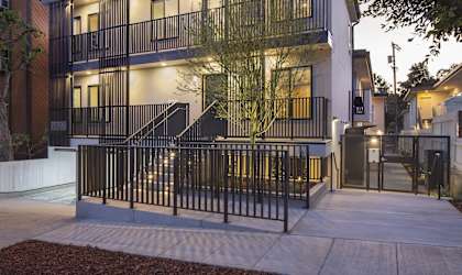 the facade of a building with stairs and a gate