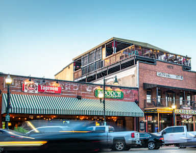 A street view of a building with a green awning and a sign that reads "Taproom".