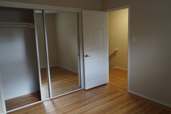 a room with a door open to a bathroom and a closet