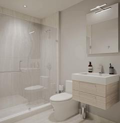 A white toilet sits next to a sink in a modern bathroom.