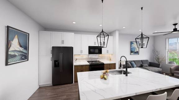 A modern kitchen with a large island and a refrigerator. at Refinery at Pointe17 Apartments, Phoenix, AZ, 85085