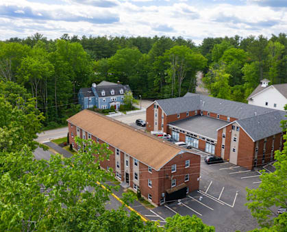 arial view of a red brick building with a brown roof