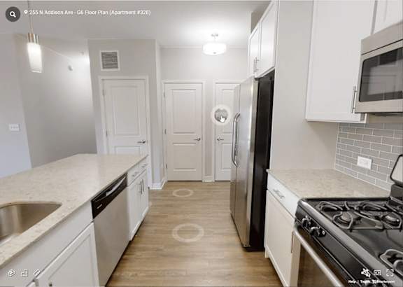 A kitchen with white cabinets and a black stove top oven.
