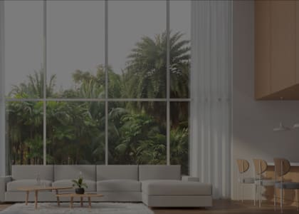 a living room with a large window overlooking palm trees