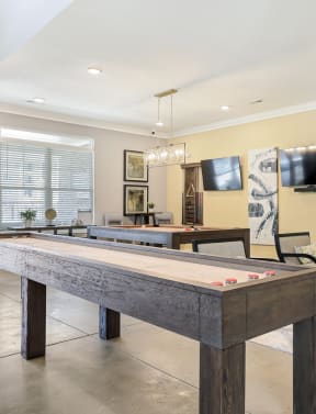 a game room with a pool table and a tv