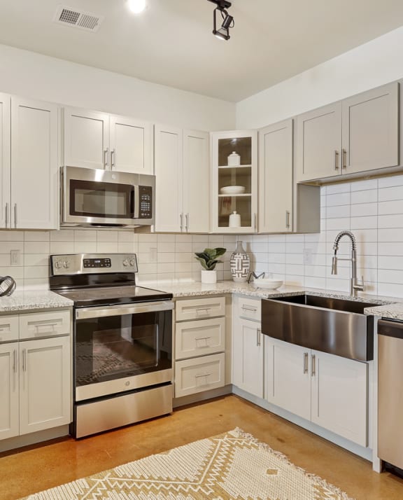 a selection of appliances in a room with geometric wallpaper