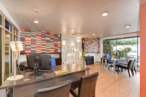 Leasing Office with Work Desks, Computer Monitors, Hardwood Inspired Floors and Window