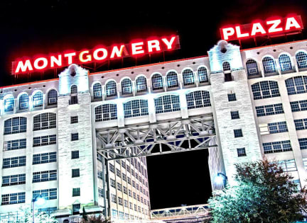 Montgomery Plaza is a large building with a prominent entrance at Aviator West 7th, Fort Worth