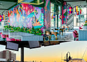 Thumbnail 6 of 8 - A colorful mural on the wall of a restaurant.