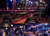 Thumbnail 7 of 8 - A gym with people exercising and treadmills with the brand name "LAGREE" on them.