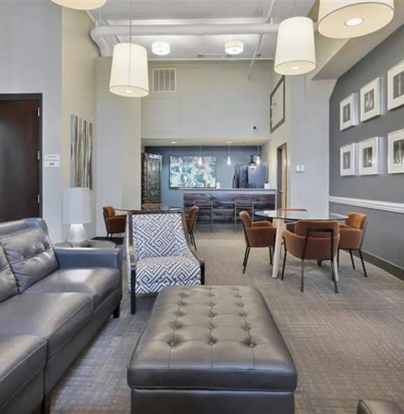 A modern living room with a grey sofa and a patterned chair.