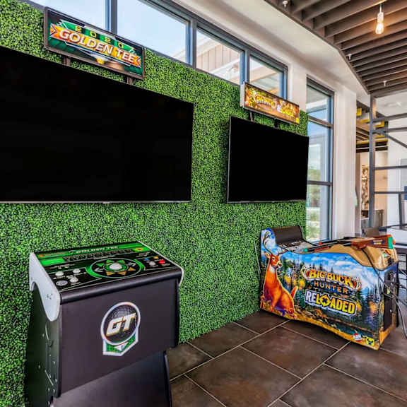 A room with a green wall and a TV mounted on it.